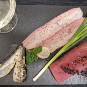 Weinglas und verschieden Sorten Fisch